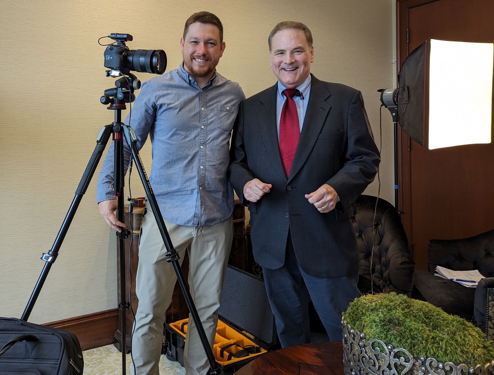 Roger and a man in front of a camera