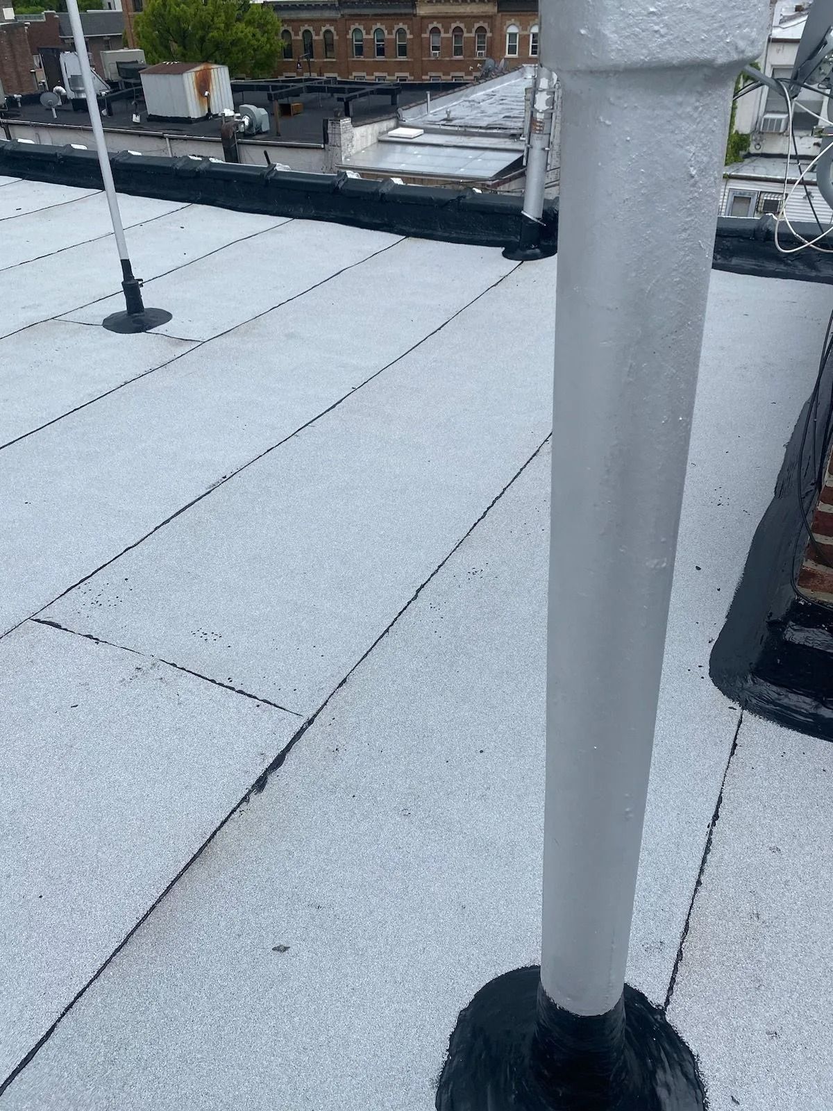 White roof with a gray pipe and black trim.