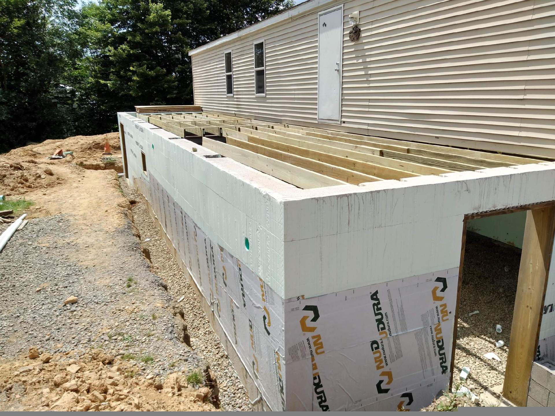 A mobile home is being built with styrofoam and wood
