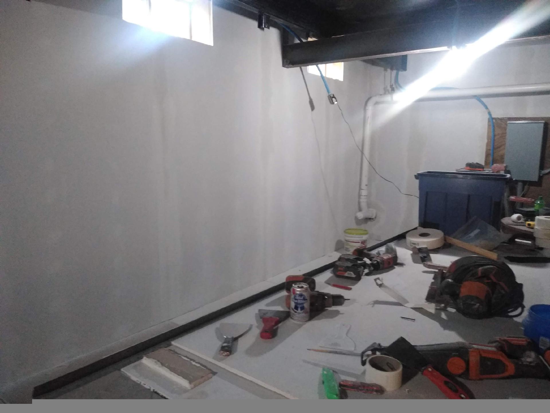 A messy room with a lot of tools on the floor