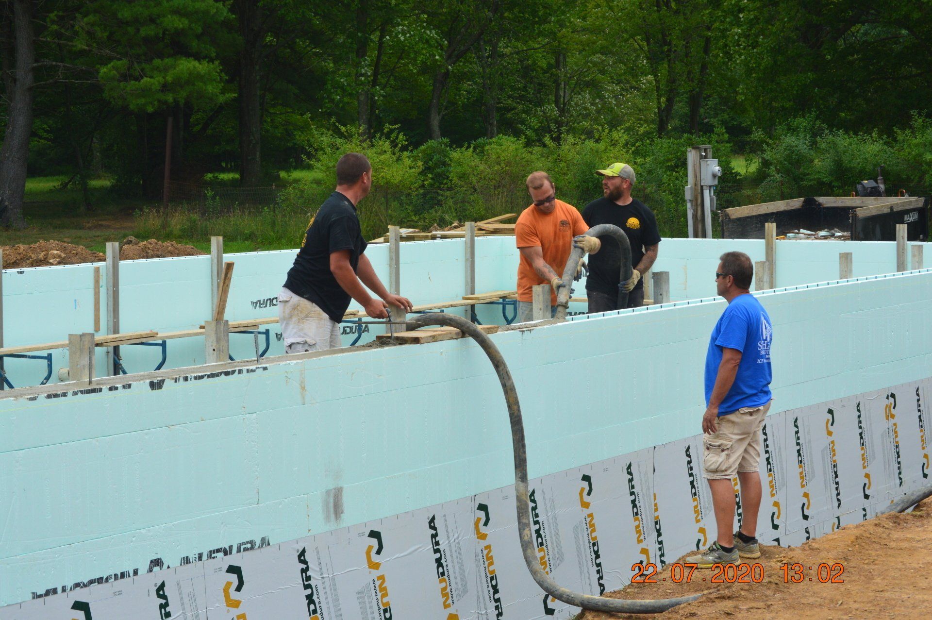 A house with a stone wall and two windows