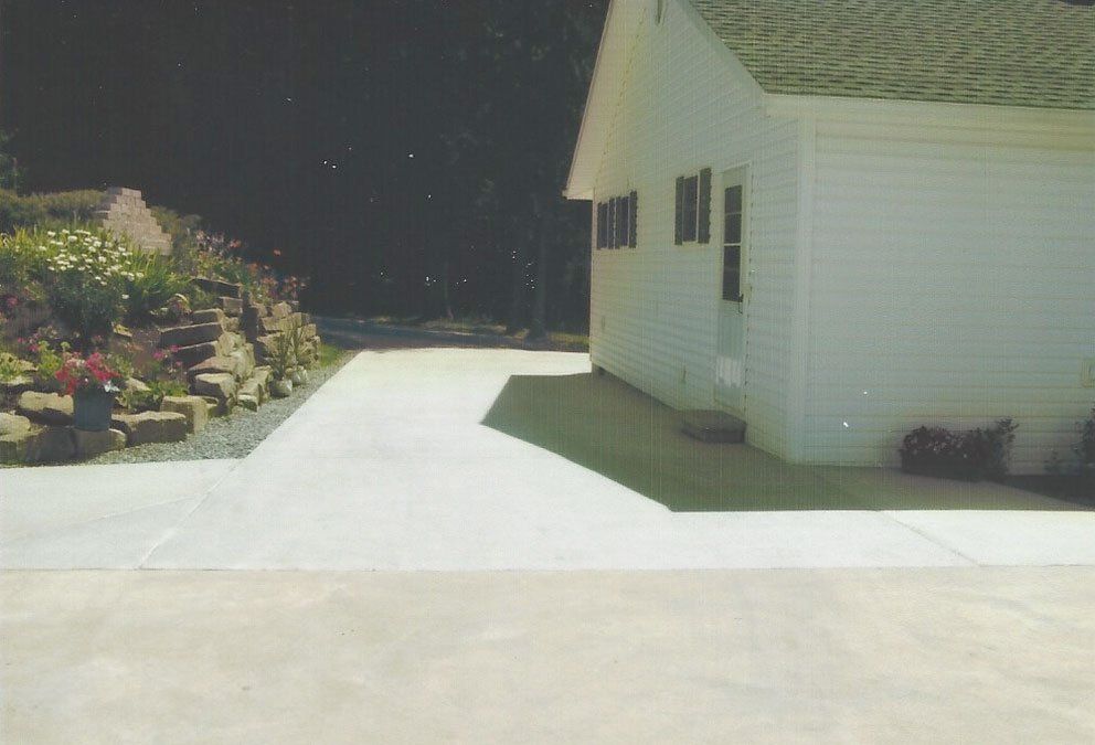 Four pictures of a building under construction with trees in the background