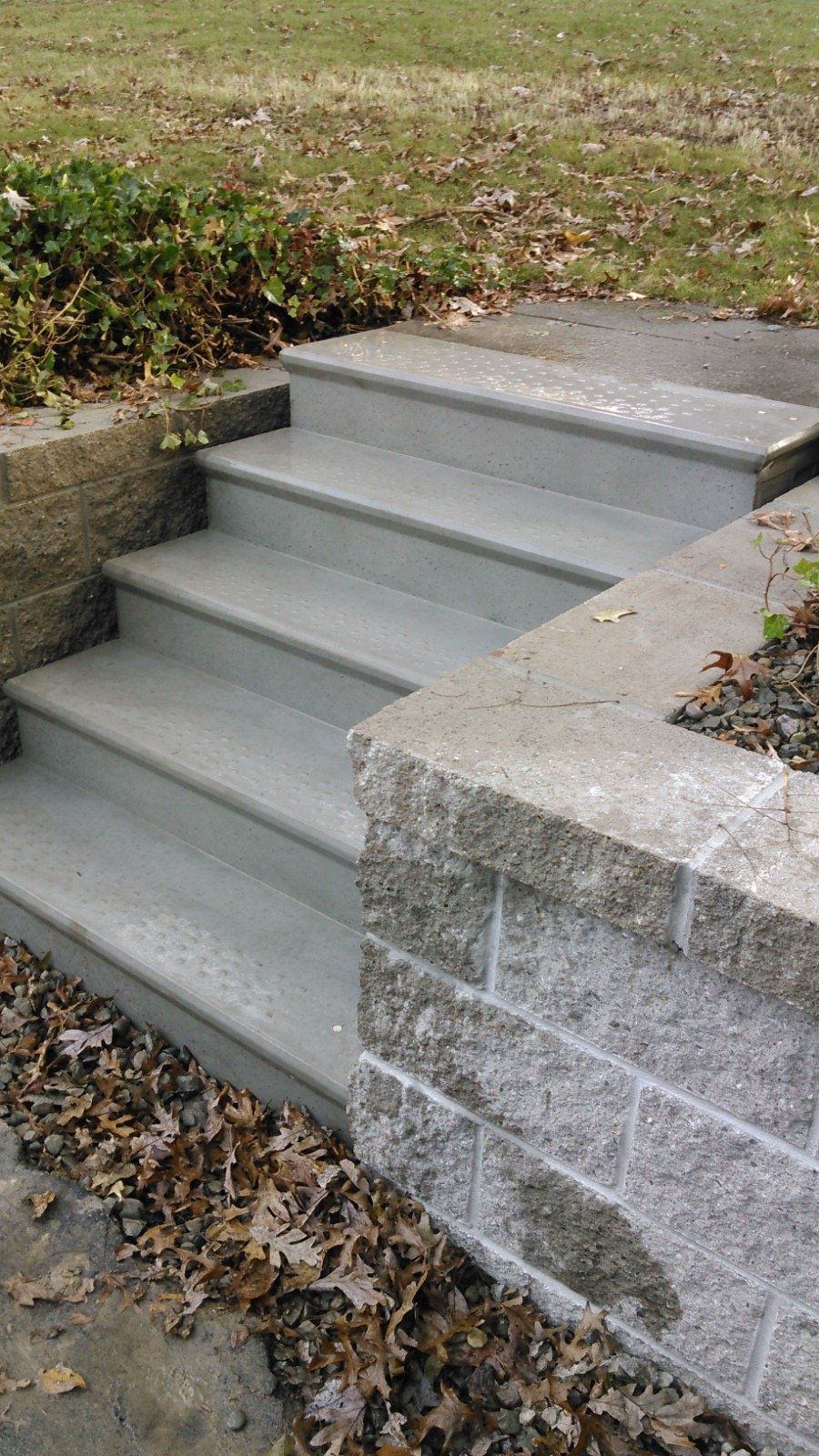 A set of stairs leading up to a brick wall