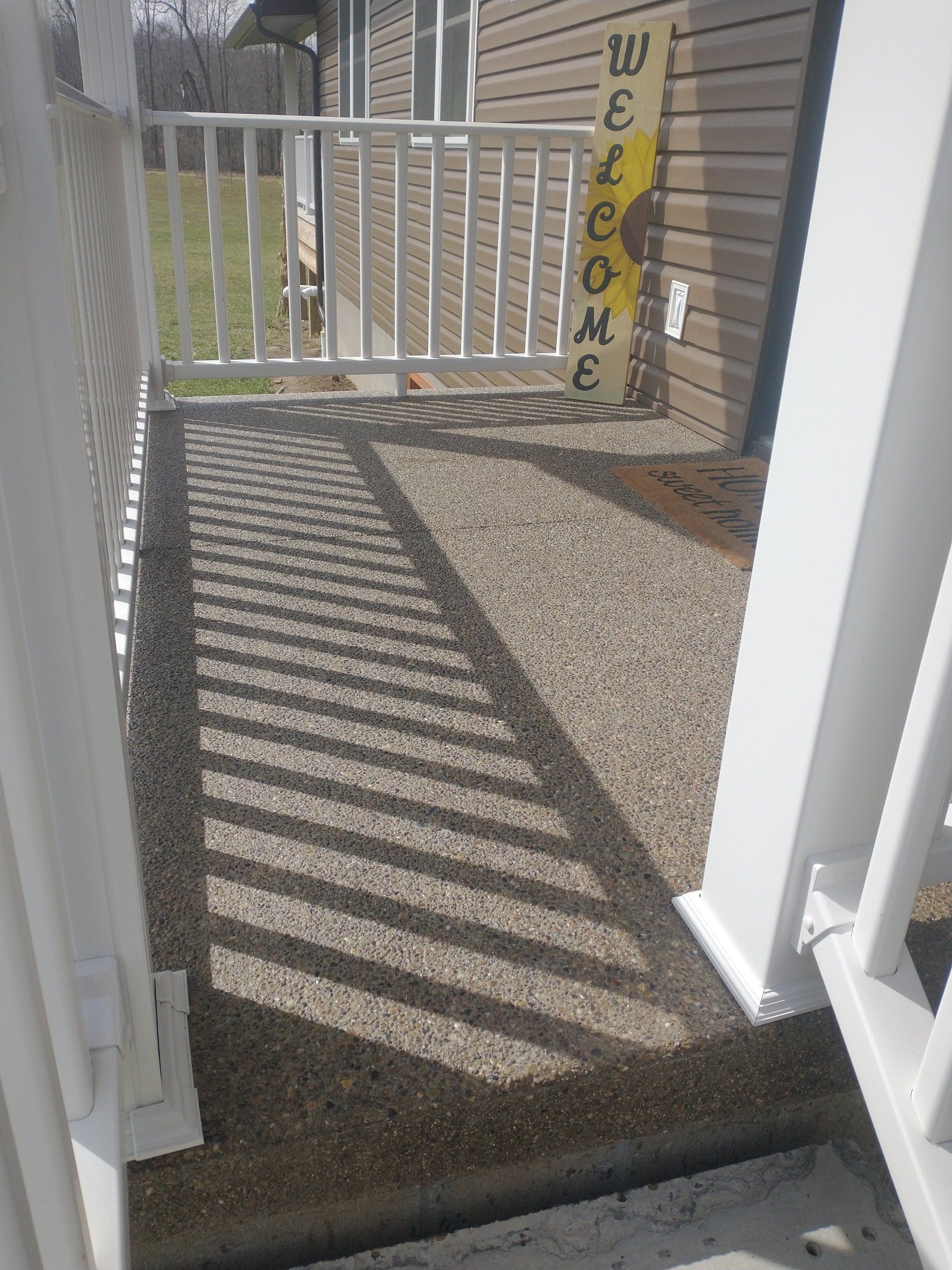 A porch with a welcome sign on it