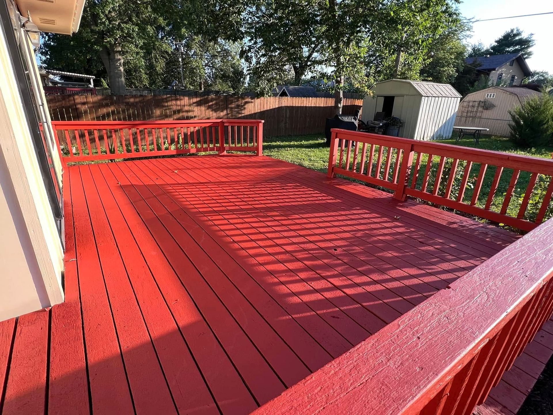 Stained out door deck red in Des Moines, IA. 