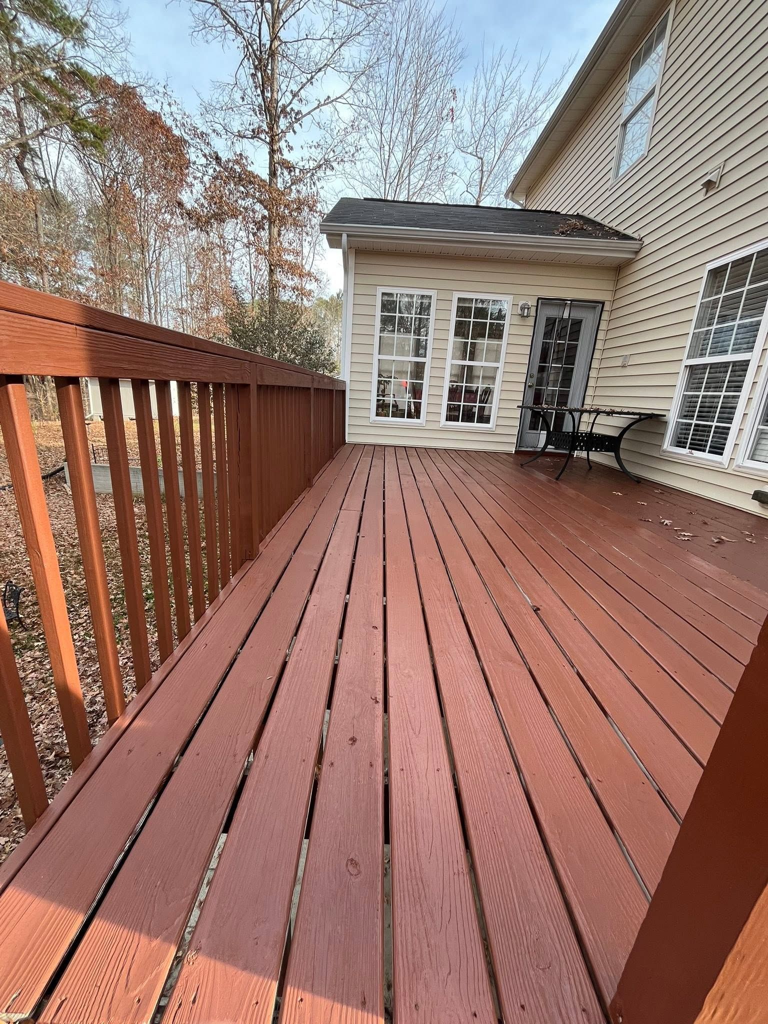 Stained wood deck red in Ankeny, Iowa.