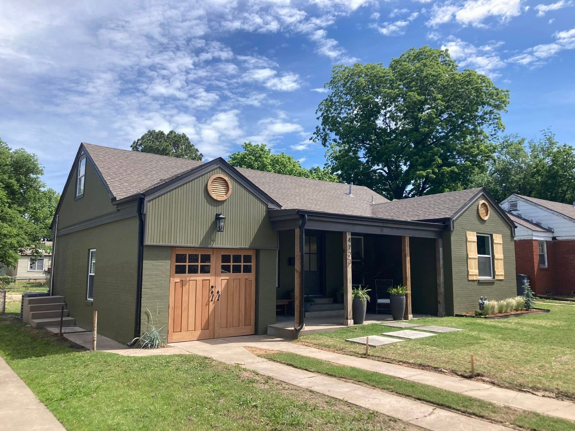 Exterior house painted green in Urbandale.