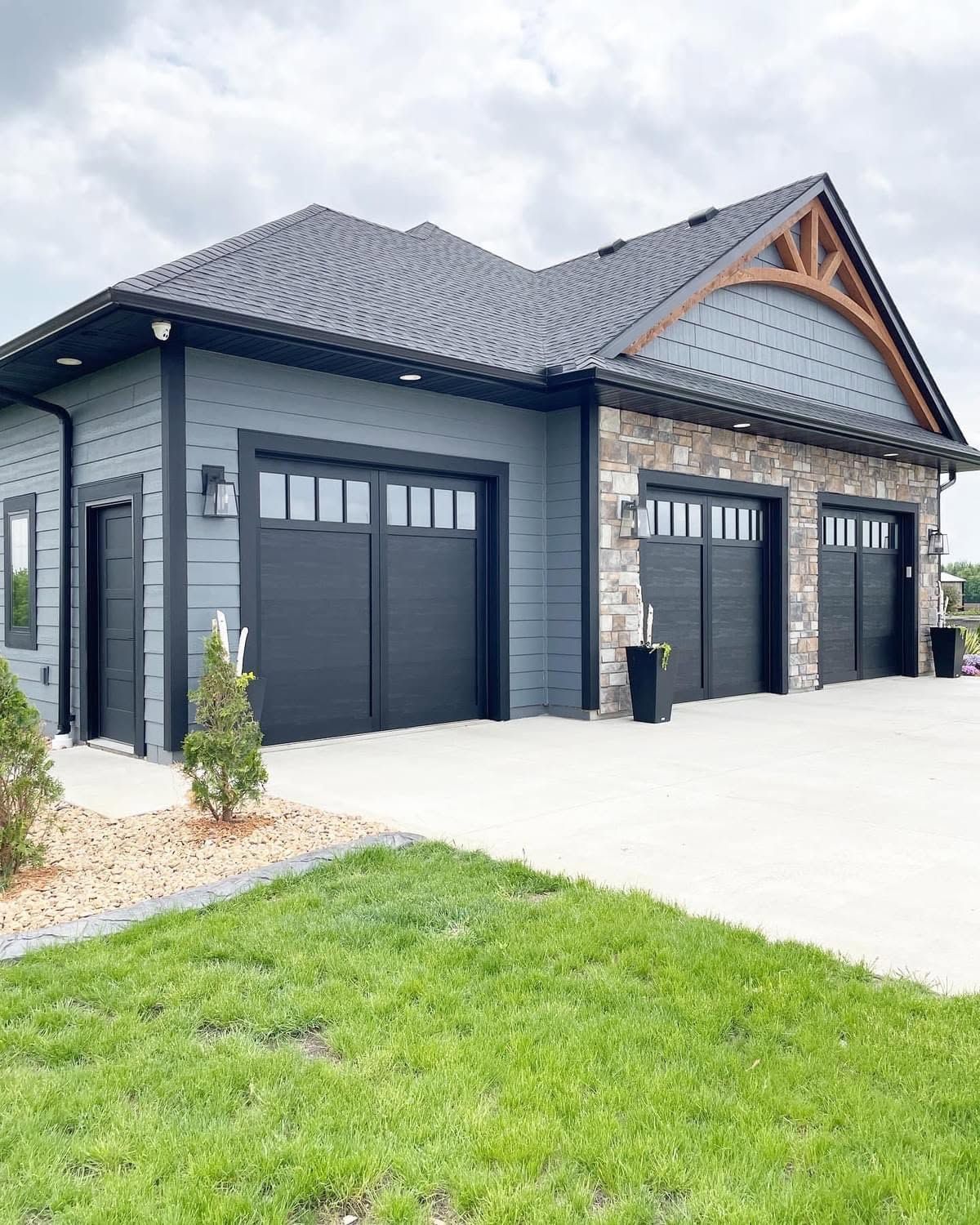 Painted house blue with black garage doors in West Des Moines, Iowa.