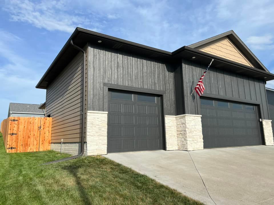 Painted exterior siding brown and cedar fence stained in Altoona, Iowa.