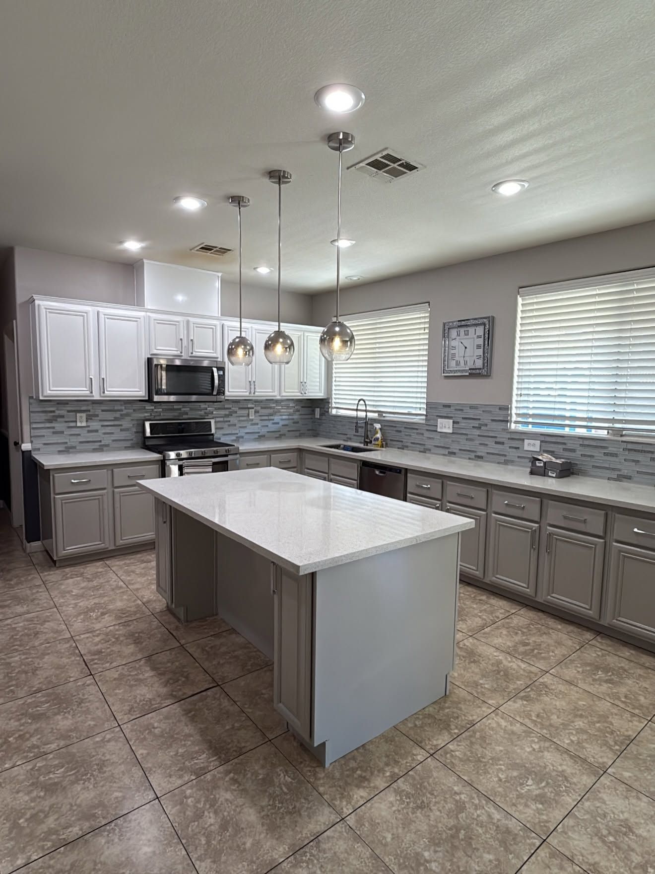 Painted kitchen cabinets gray and white in Ankeny, Iowa. 