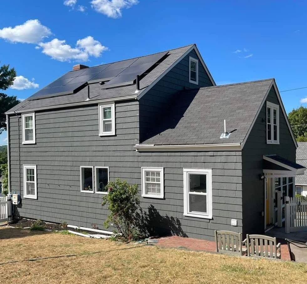 Painted 3 story house gray with white trim in West Des Moines, Iowa.