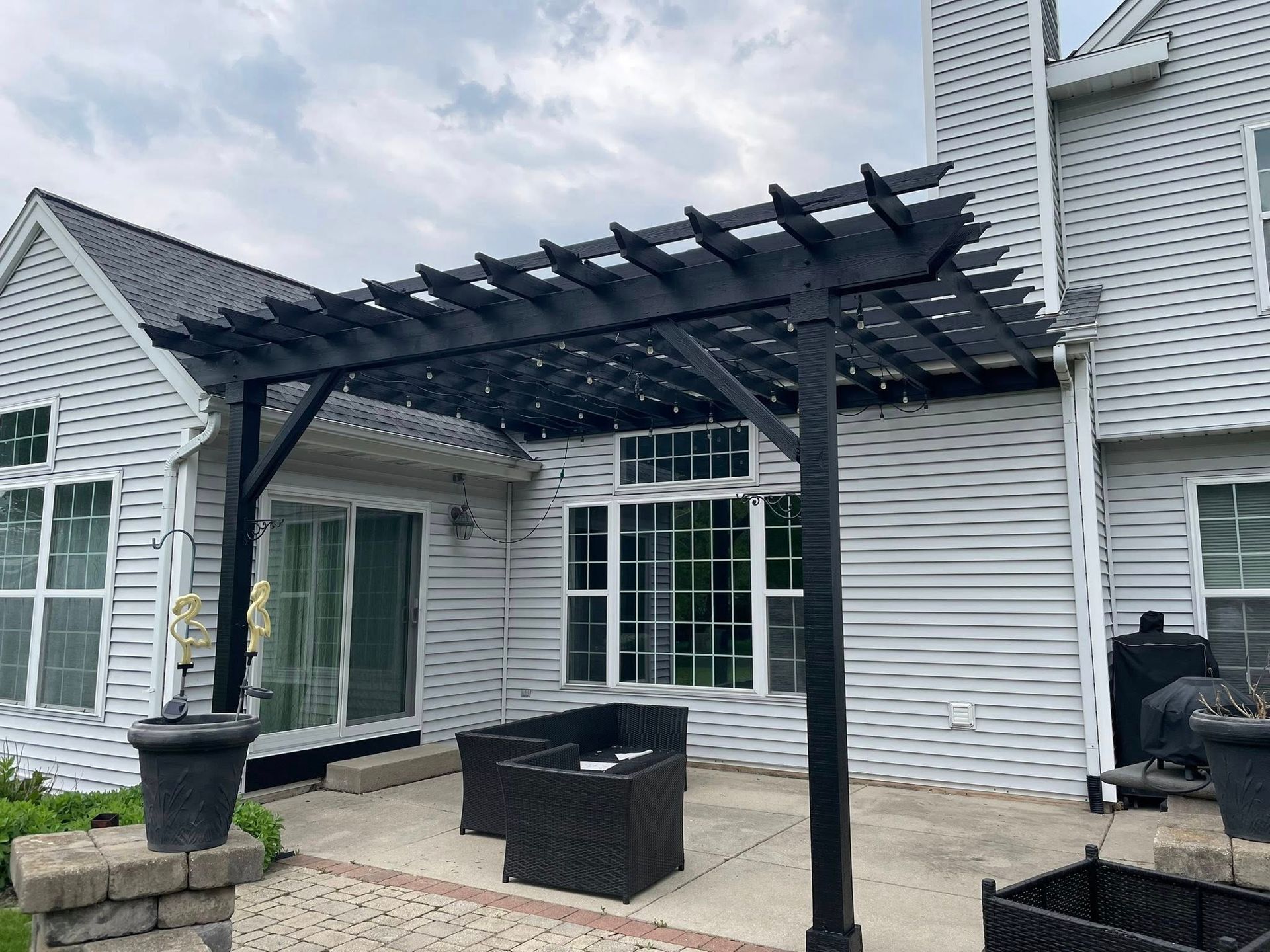 Stained pergola black on deck in Urbandale, IA.