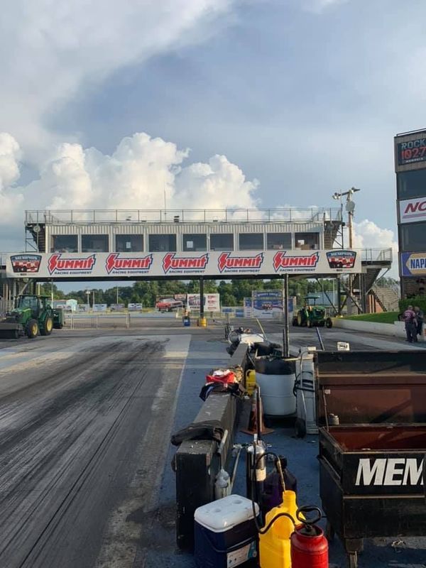 Drag strip scene with a control tower branded
