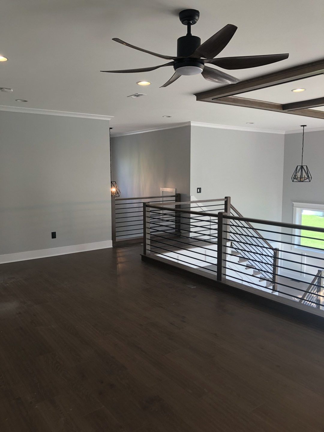 There is a ceiling fan in the middle of the room.