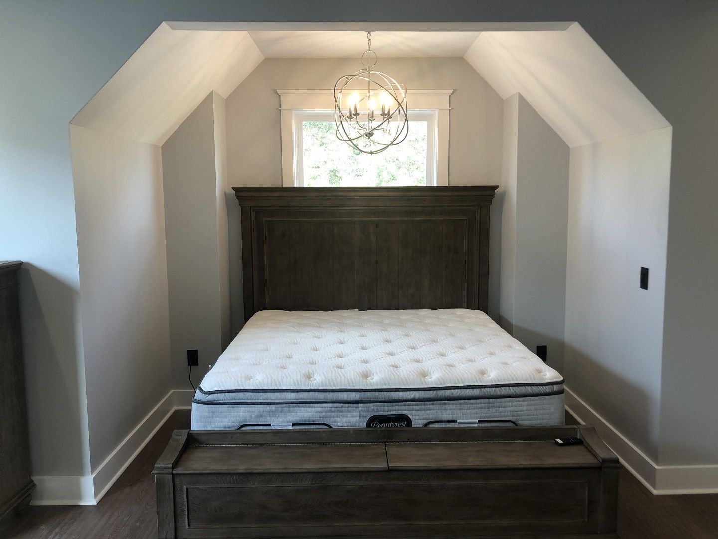 A bedroom with a large bed and a window