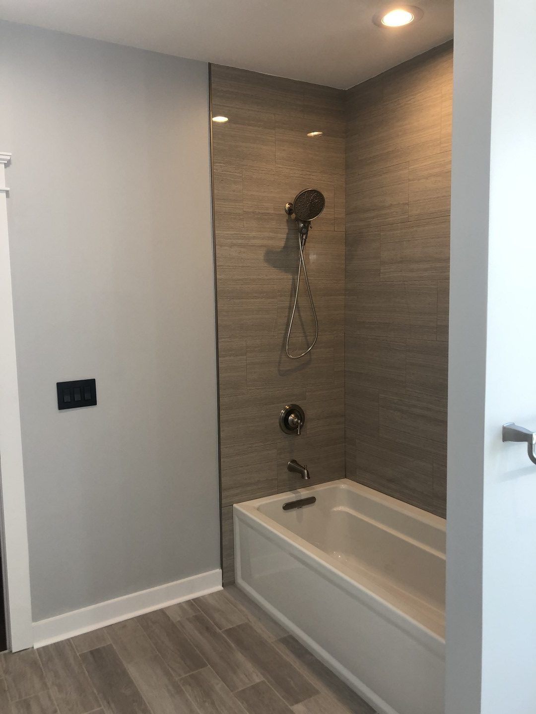A bathroom with a bathtub and a shower.