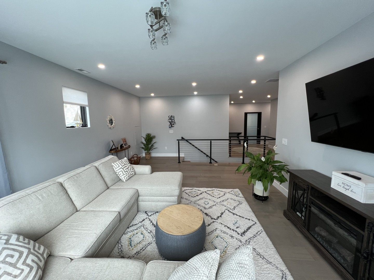 A living room with a couch and a flat screen tv.