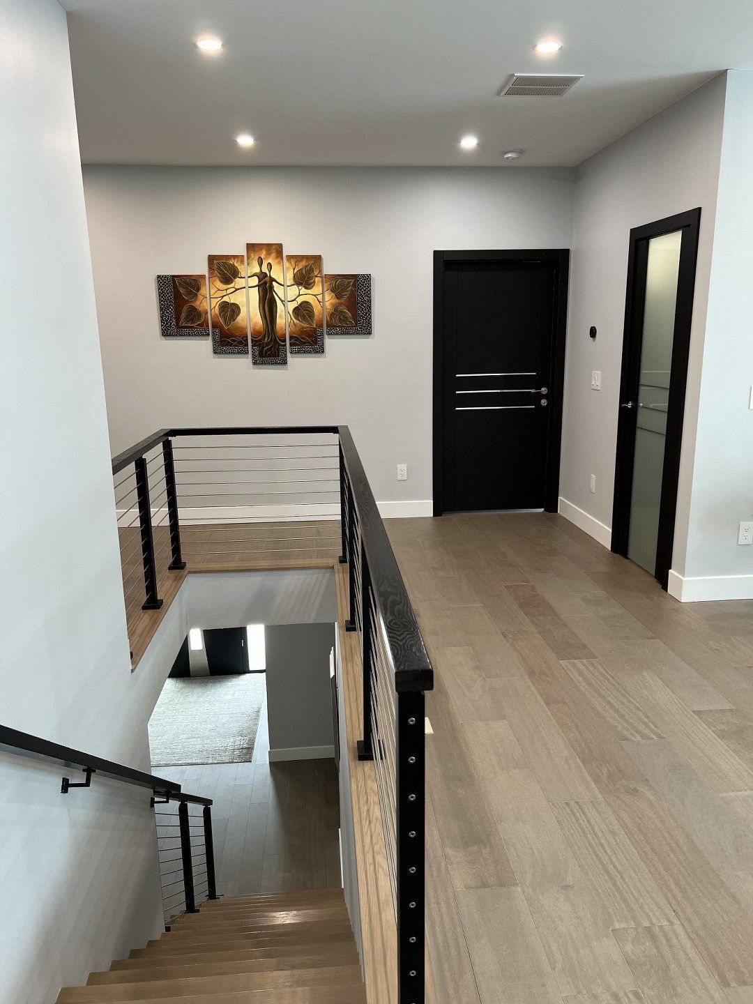 A hallway with stairs leading up to the second floor of a house.