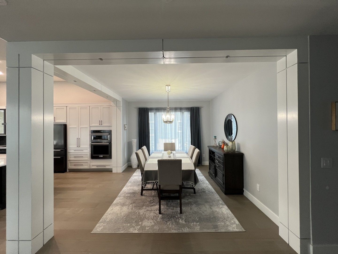 A large dining room with a long table and chairs