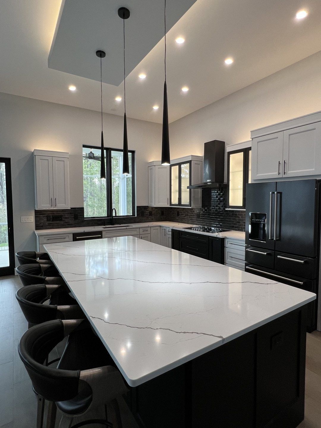 A kitchen with a long table and chairs in it