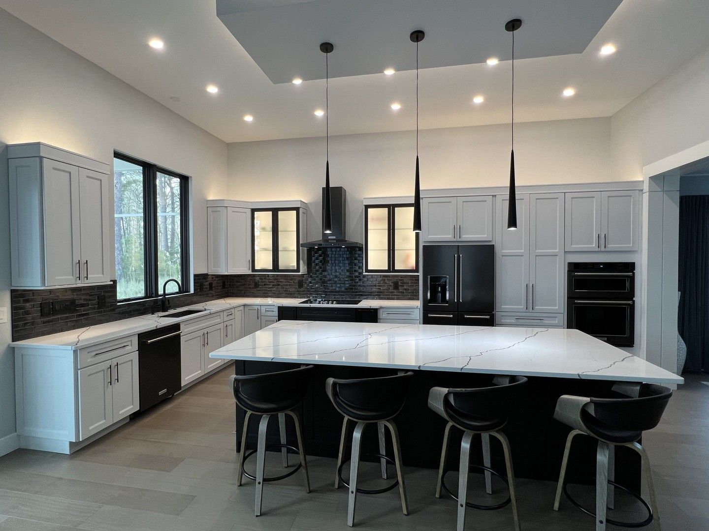 The back of a large house with a screened in porch.