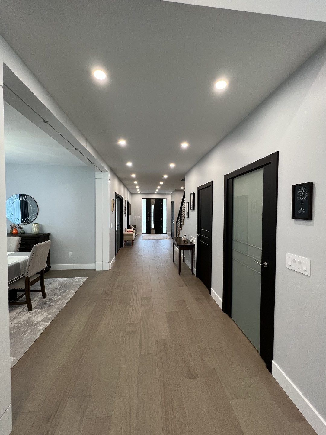 A long hallway leading to a dining room and a living room.