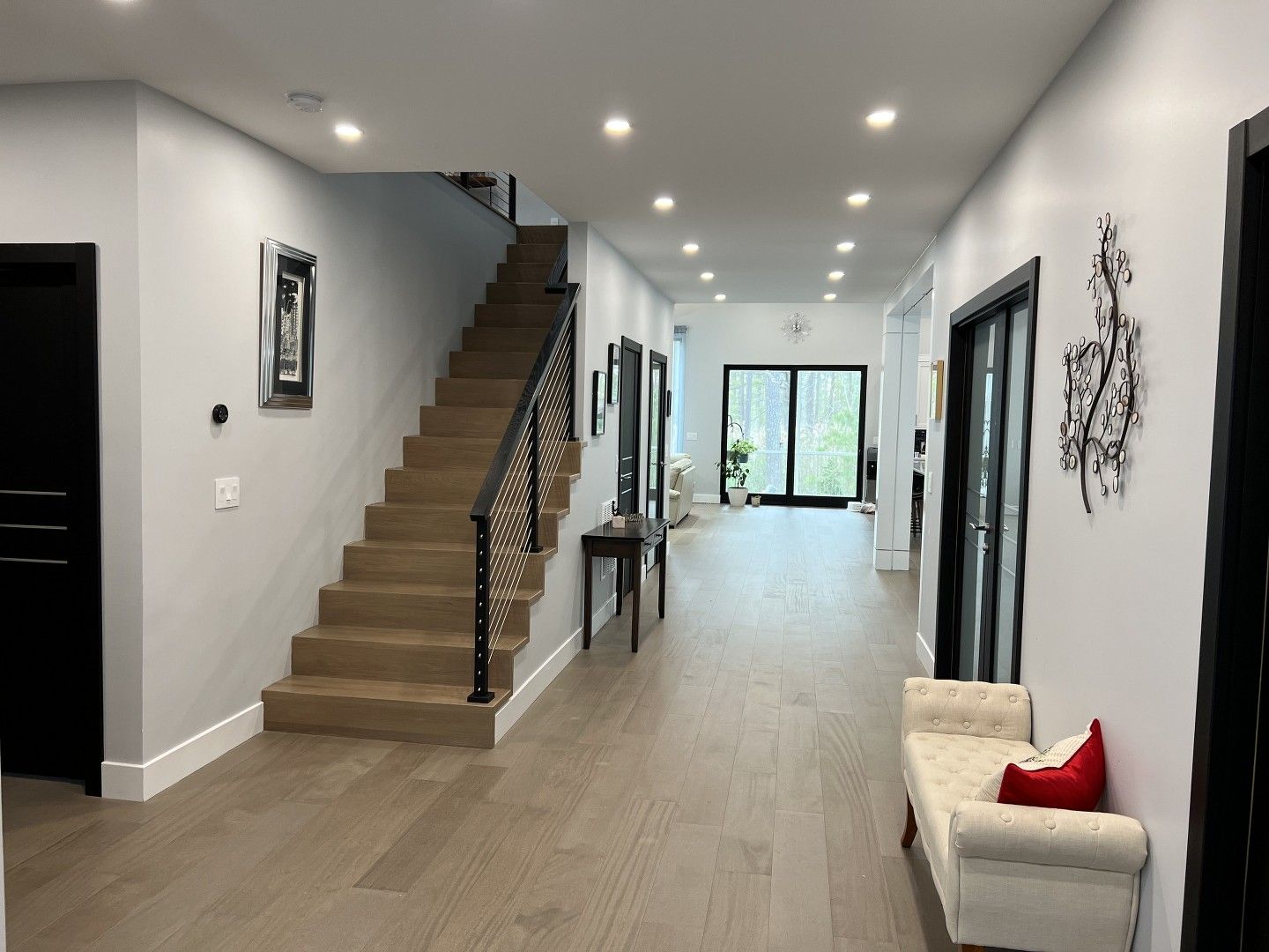 A hallway with stairs leading up to the second floor of a house.