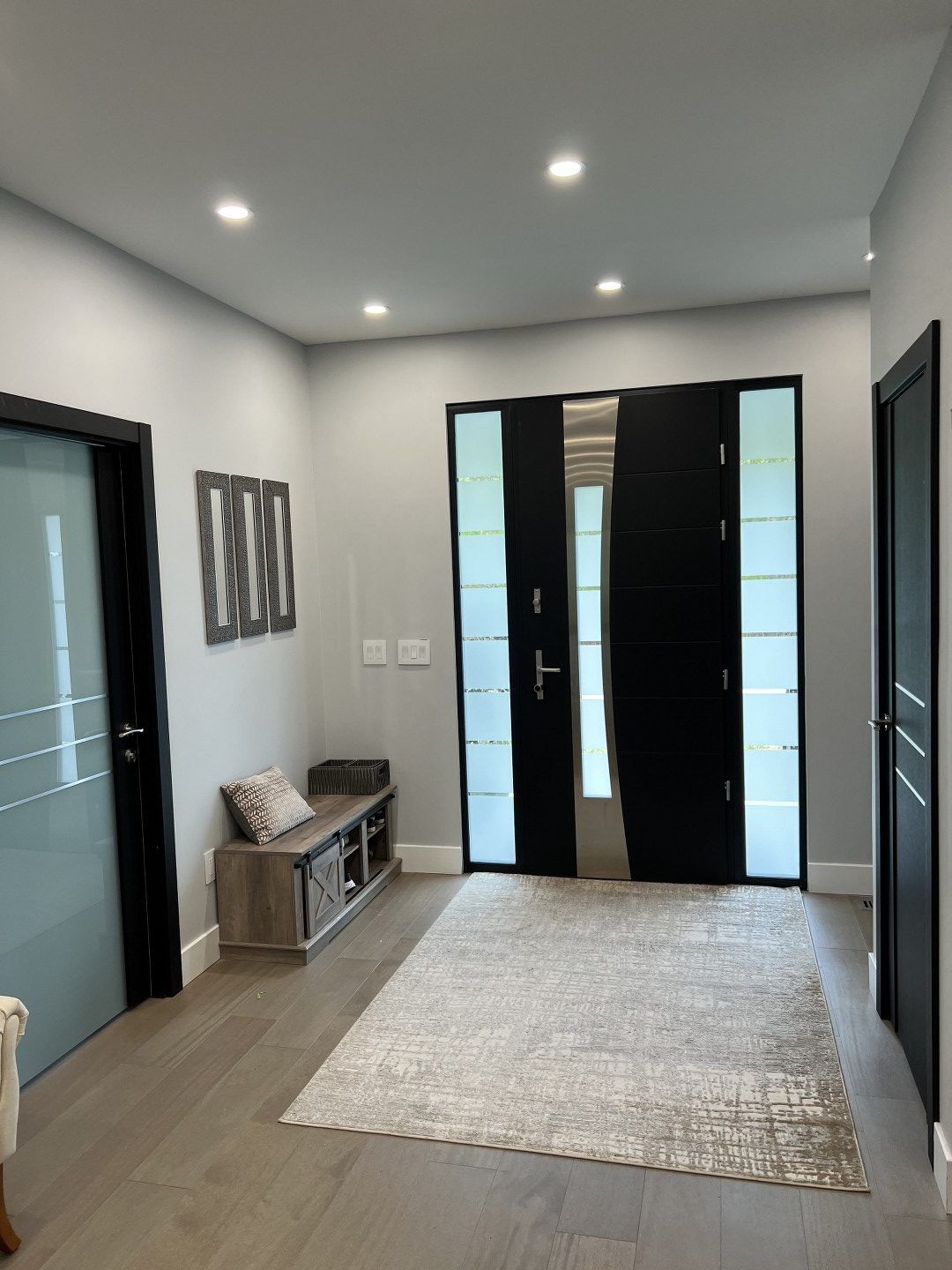 A hallway with a rug and a bench in it