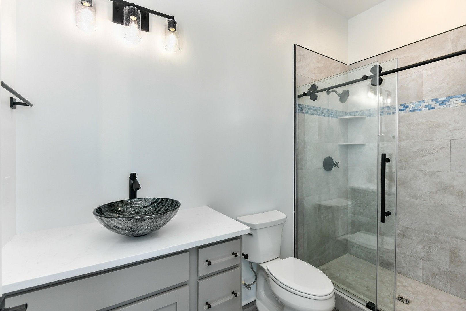 A bathroom with a toilet , sink , and shower.