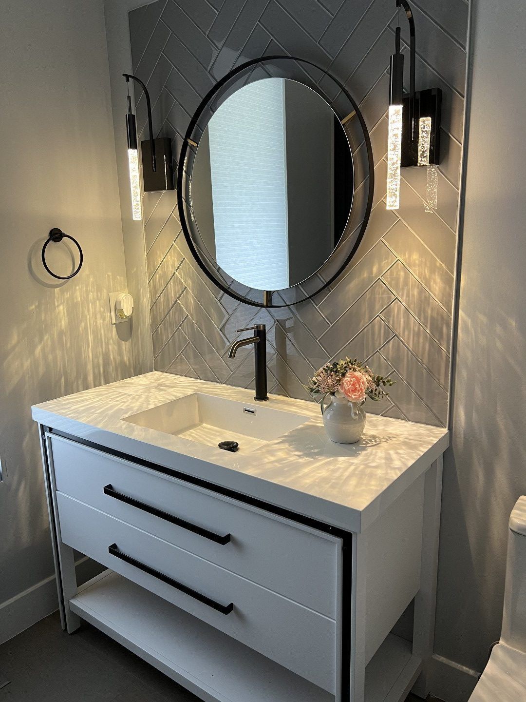A bathroom with a sink , mirror and toilet.