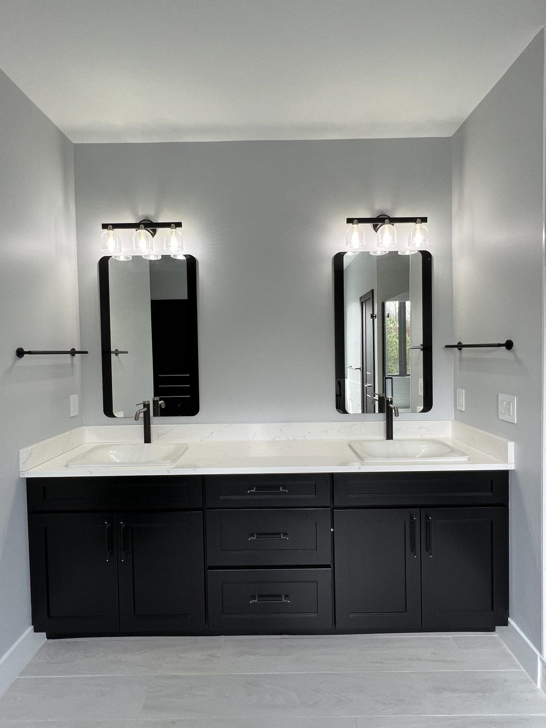 A bathroom with two sinks and two mirrors
