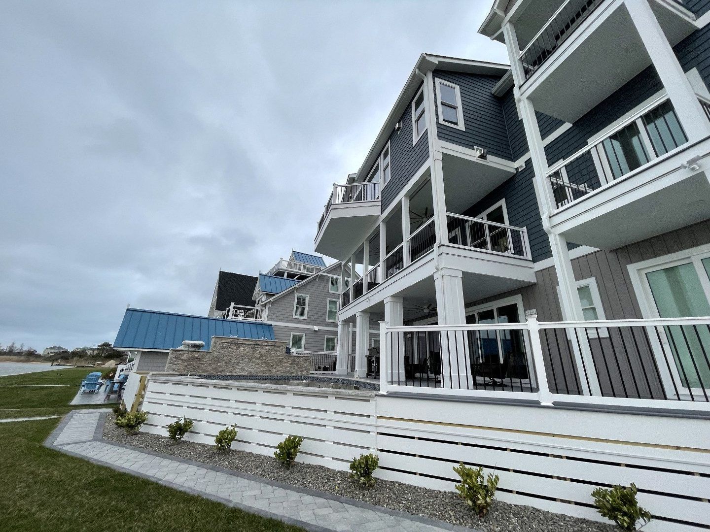 A large house with a lot of balconies and a white railing.