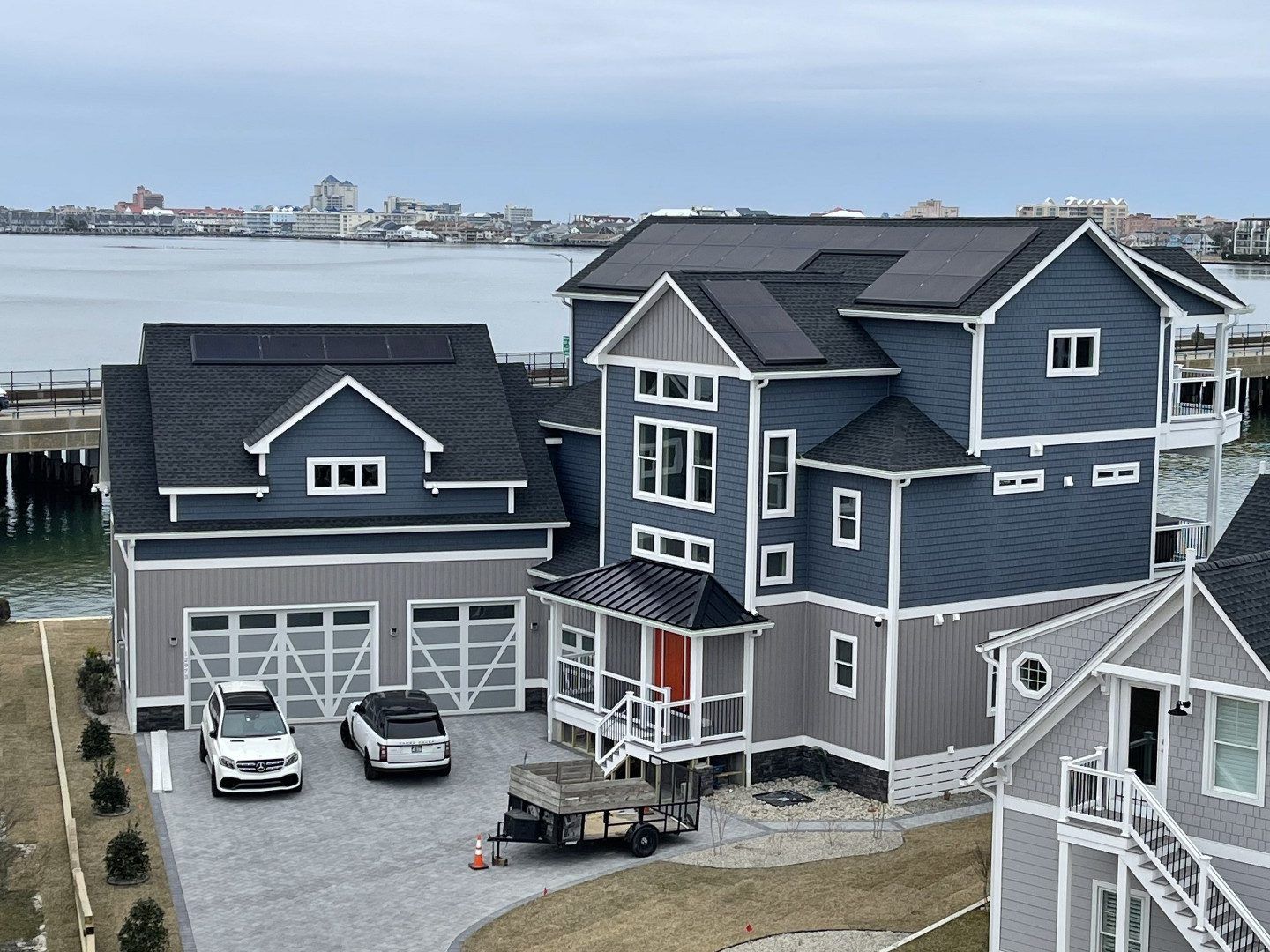 A large house with a lot of cars parked in front of it