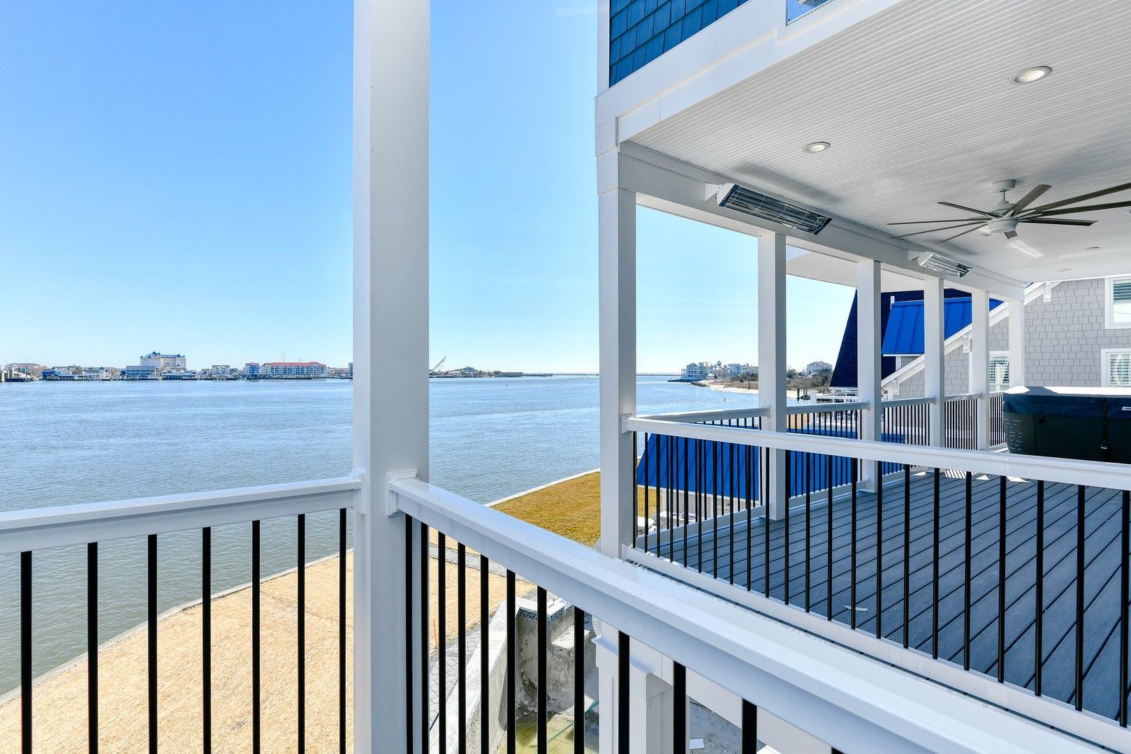 A balcony with a view of the ocean and a hot tub.