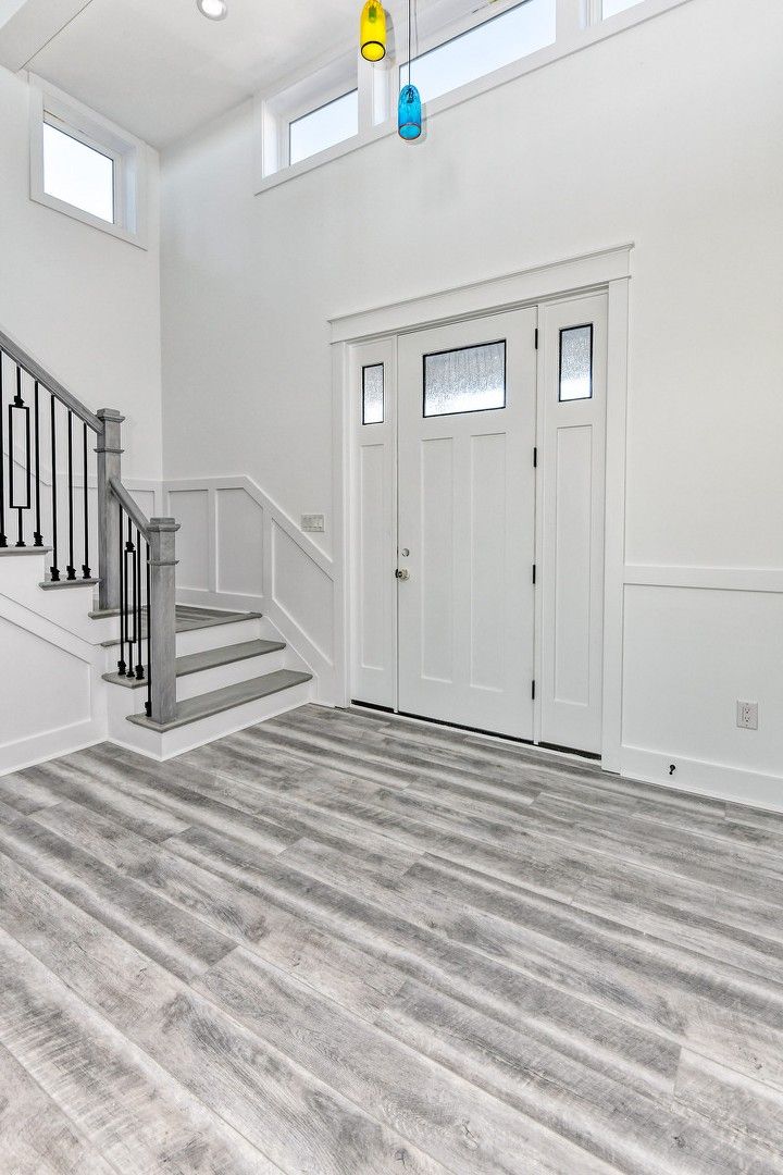 There is a staircase leading up to the front door of the house.