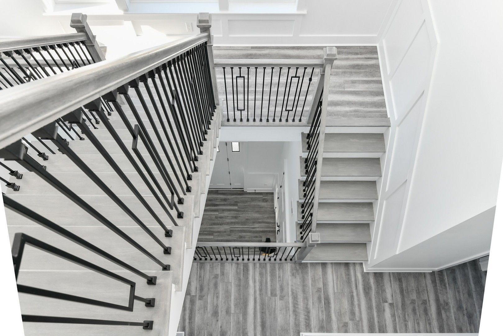 A black and white photo of a staircase in a house.