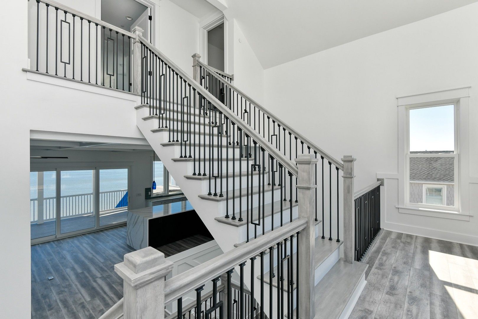 A staircase in a house with a view of the ocean.