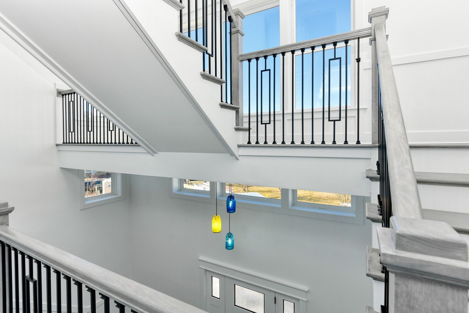 A view of a staircase from the second floor of a house.