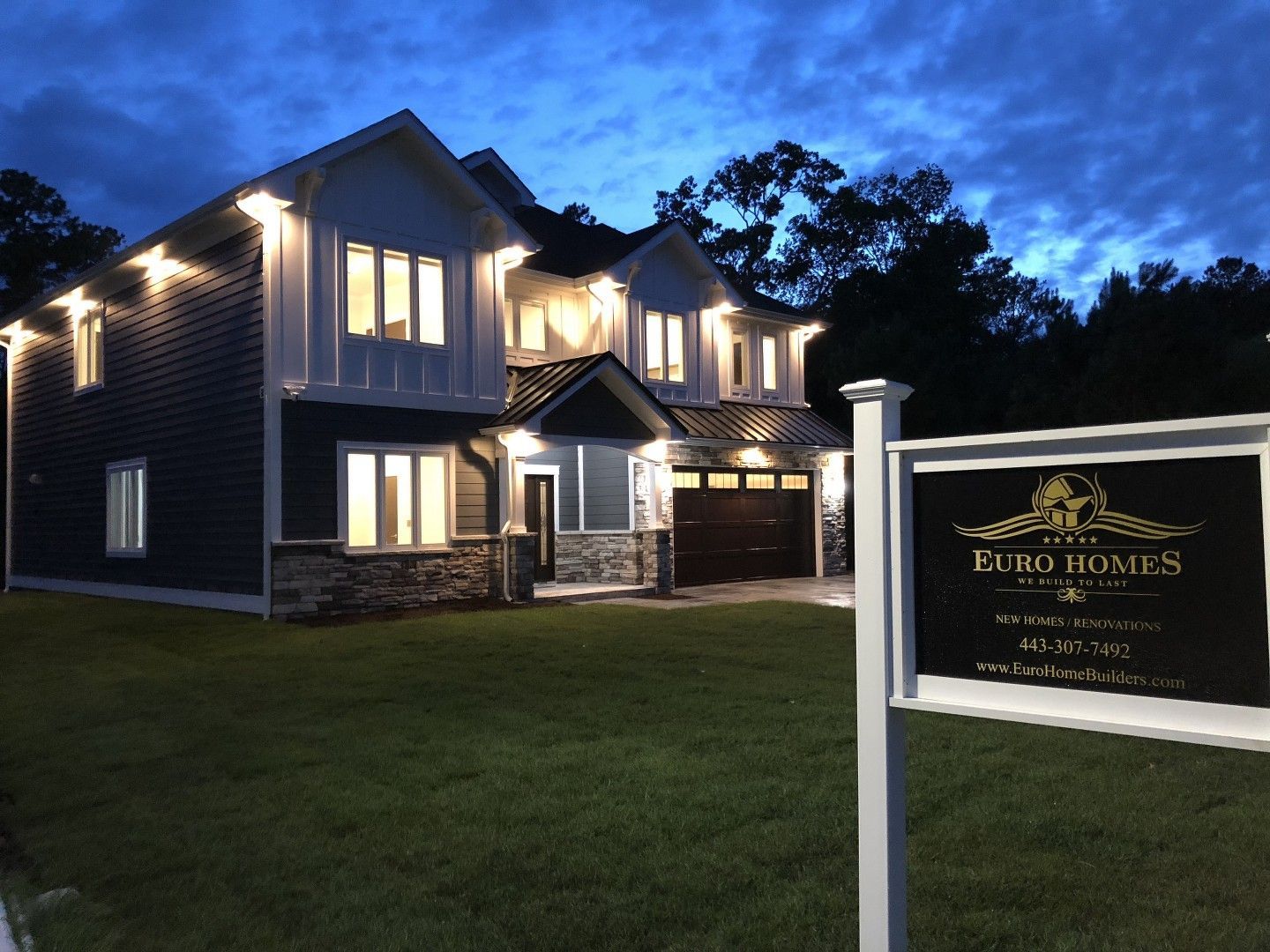 A large house with a euro homes sign in front of it