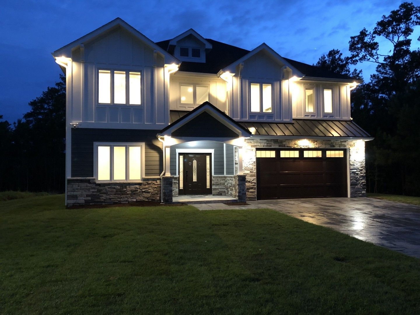 The front of a house is lit up at night