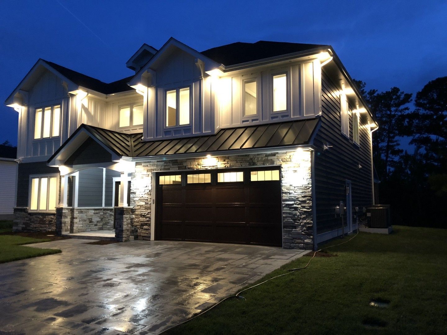 A large house is lit up at night