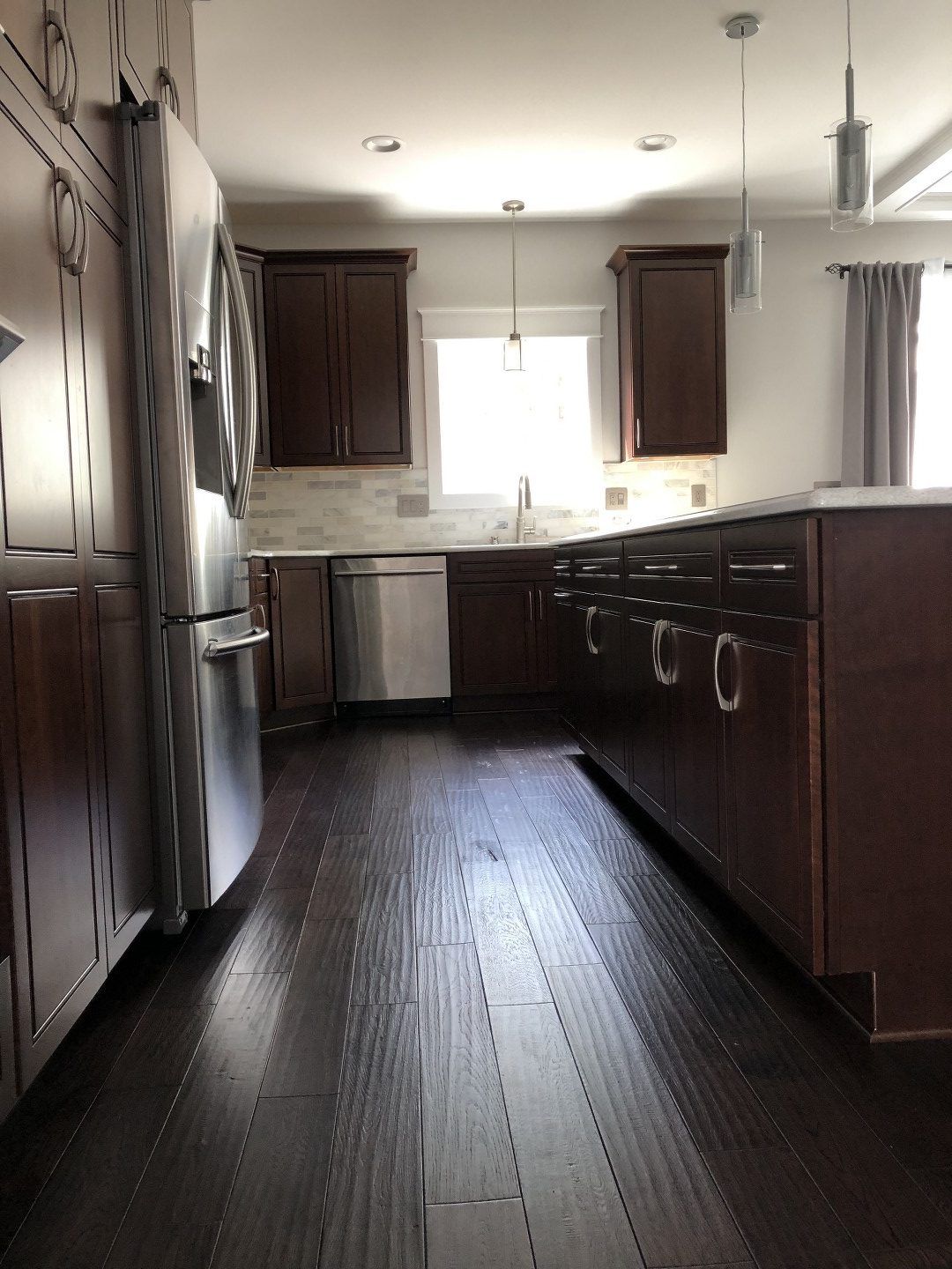 A kitchen with stainless steel appliances and wooden cabinets