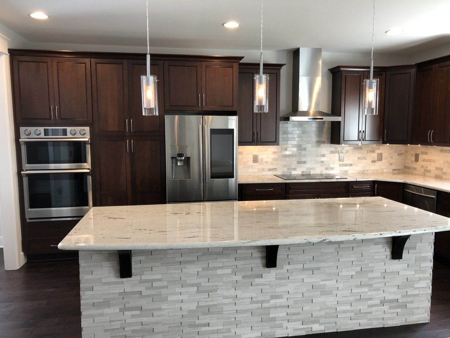 A kitchen with a large island and stainless steel appliances