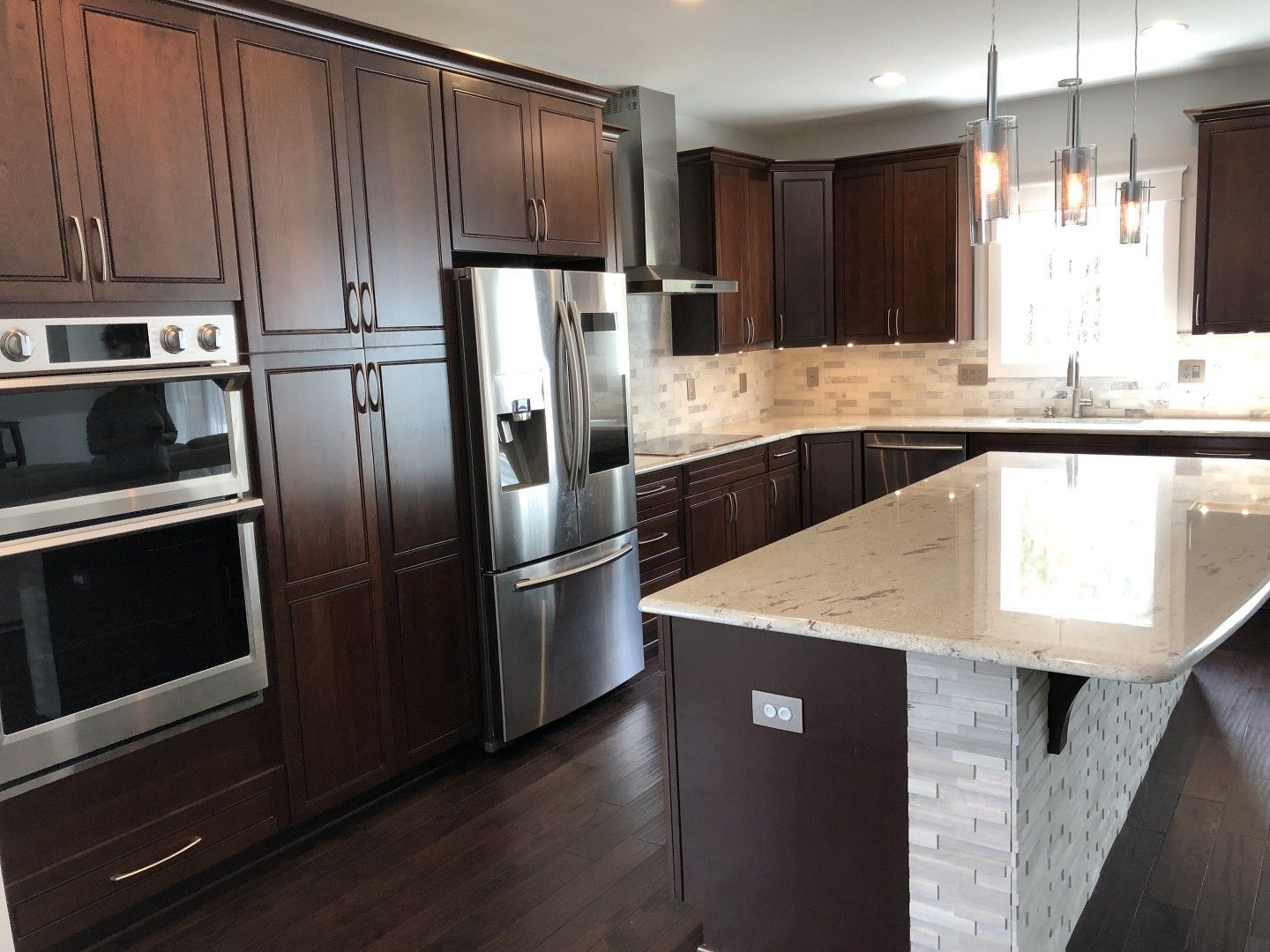 A kitchen with stainless steel appliances and wooden cabinets
