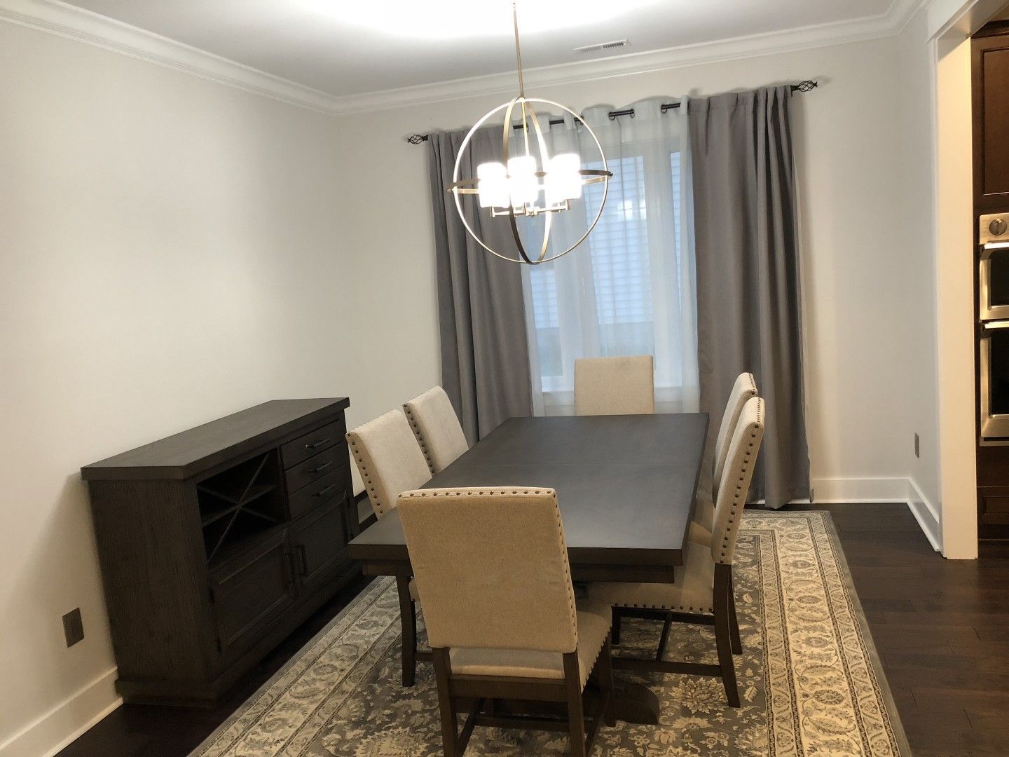 A dining room with a long table and chairs