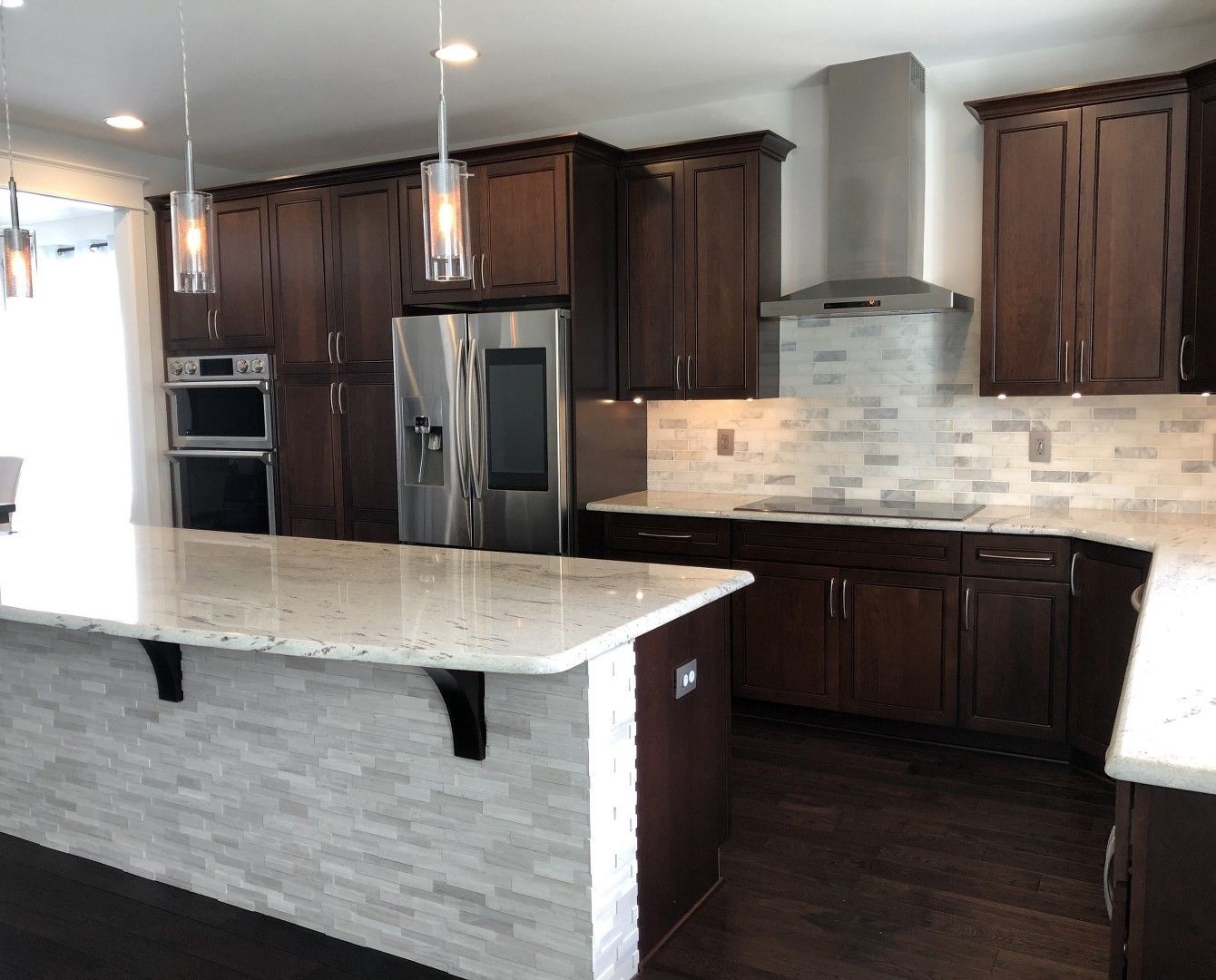 A kitchen with stainless steel appliances and wooden cabinets