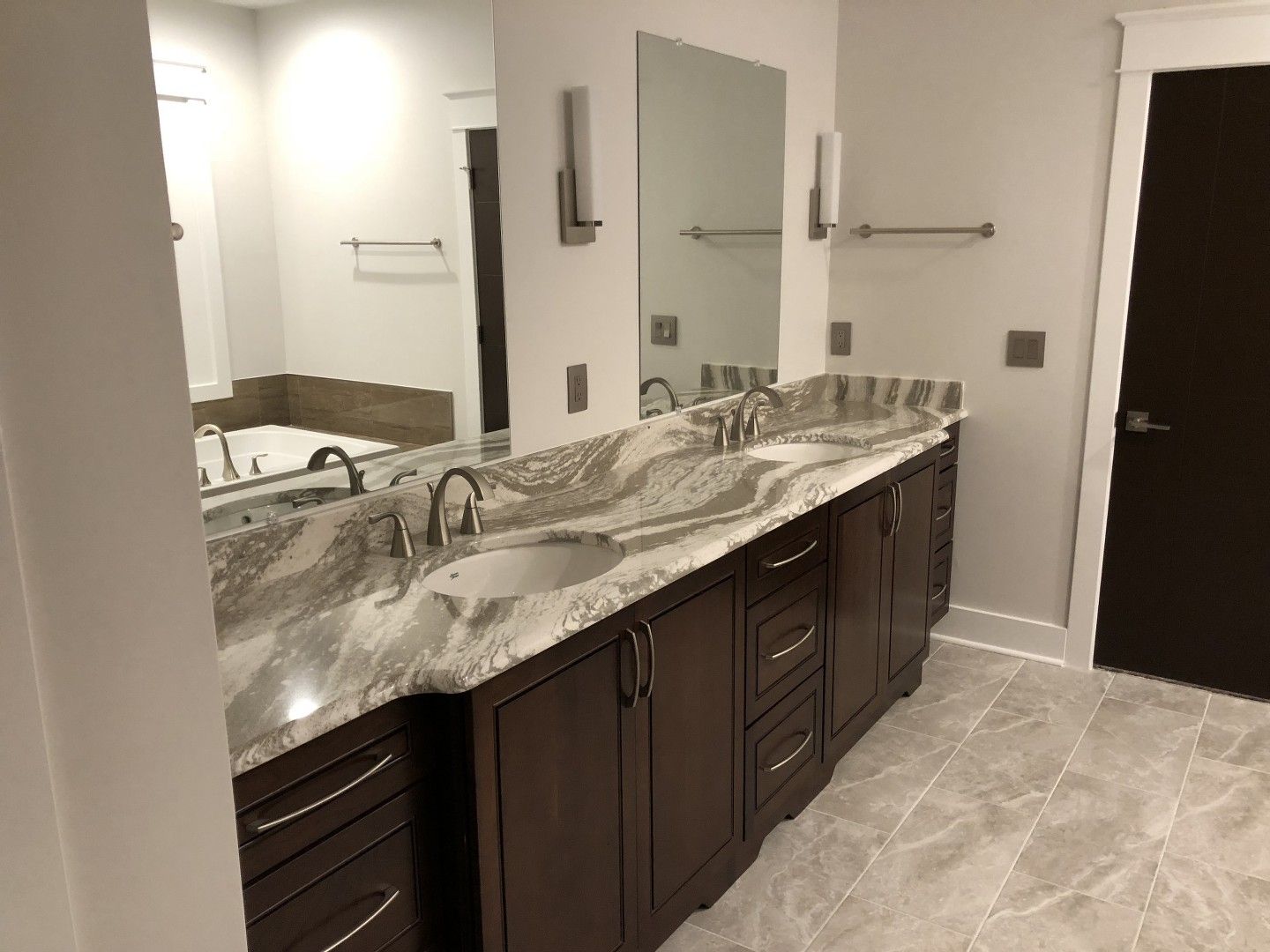 A bathroom with two sinks and two mirrors.