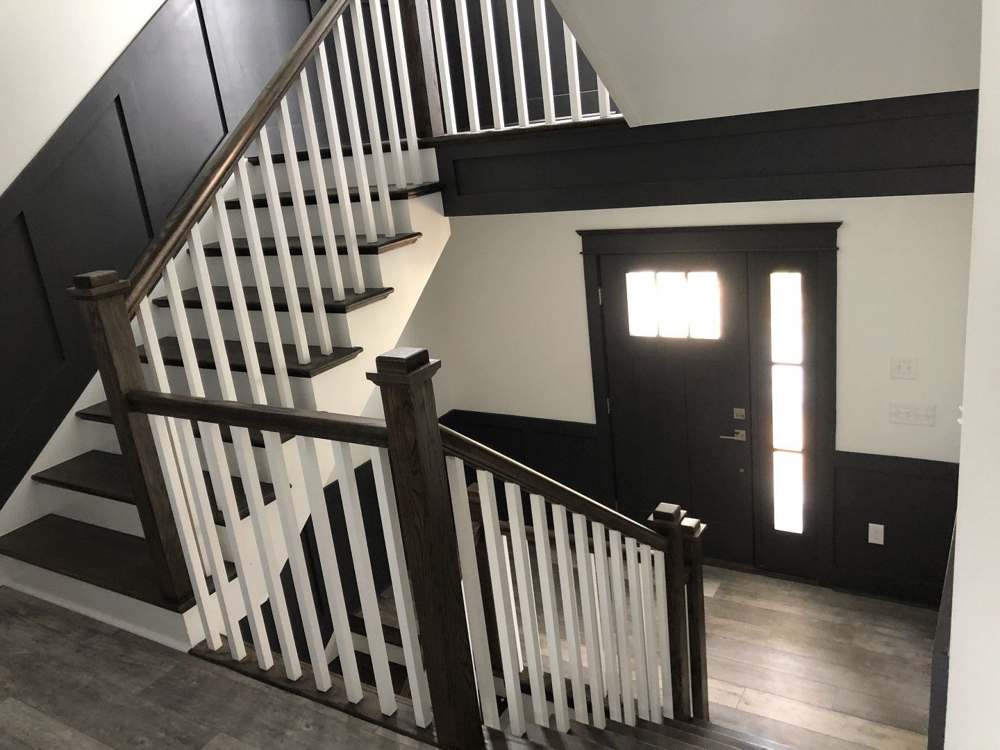 A staircase with a wooden railing leading up to a door.