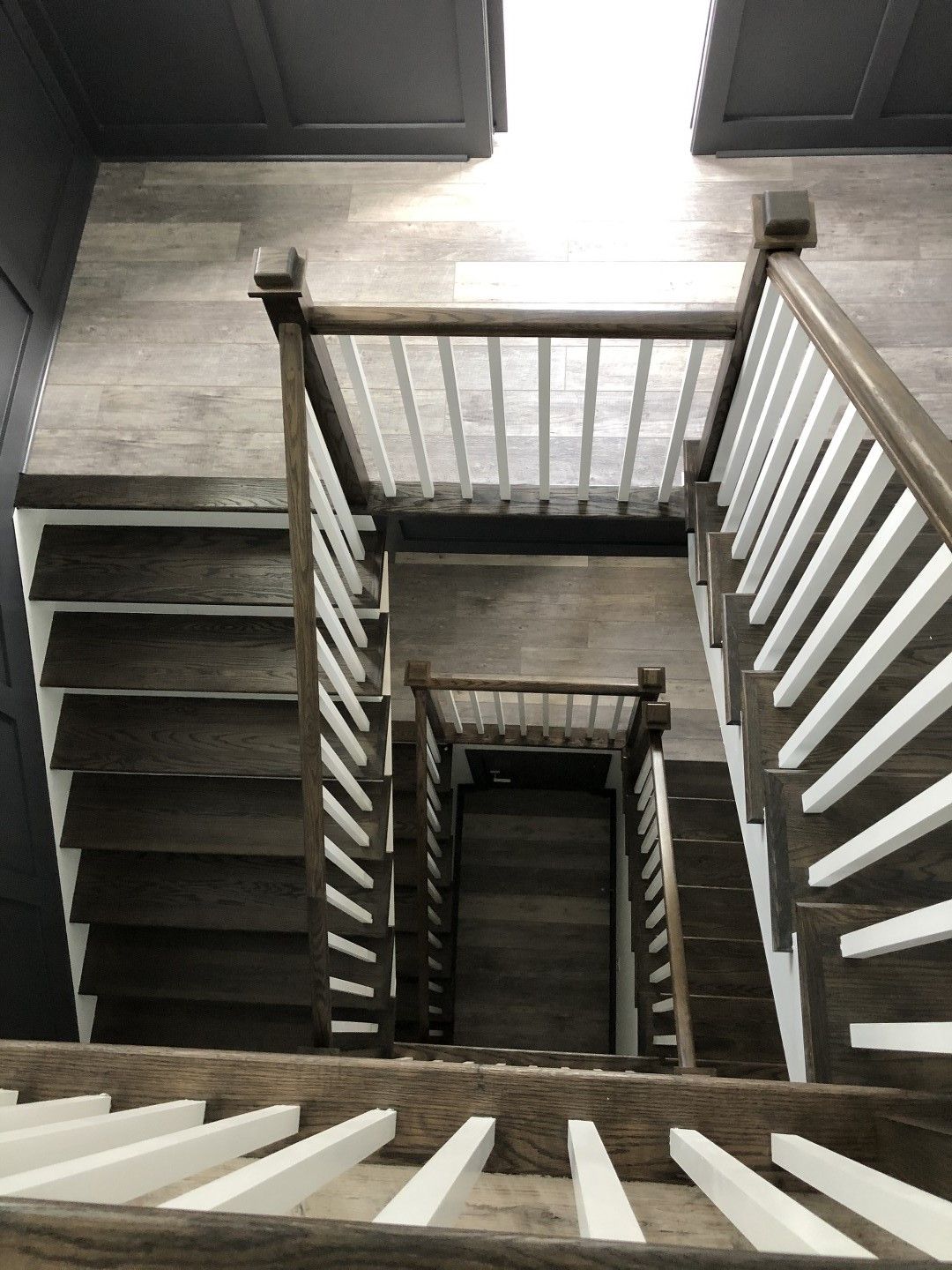 The stairs are made of wood and have white railings.