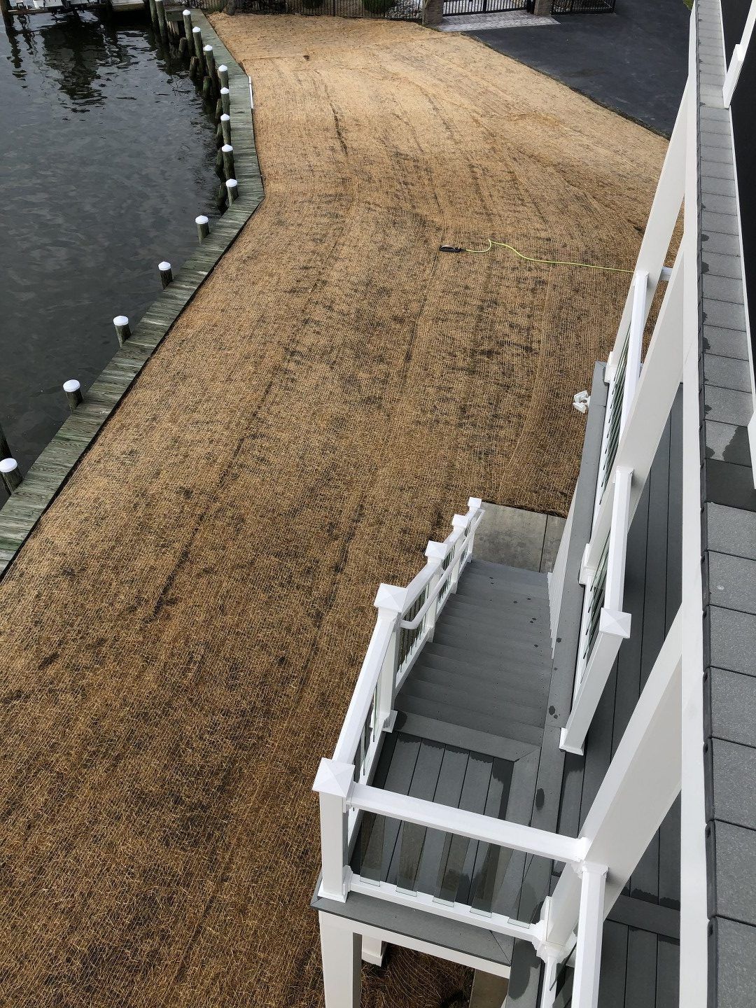 An aerial view of a house next to a body of water.
